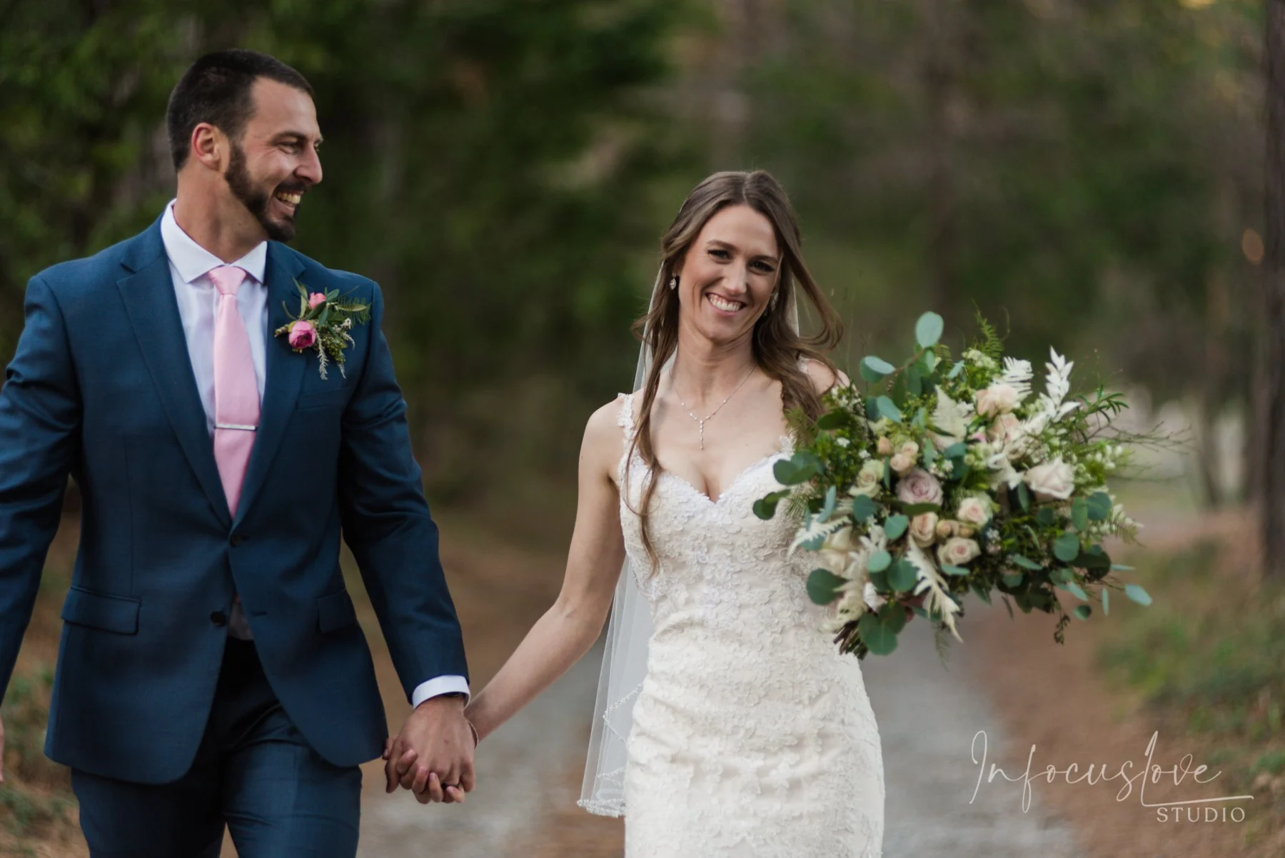 A wedding couple smiling outside