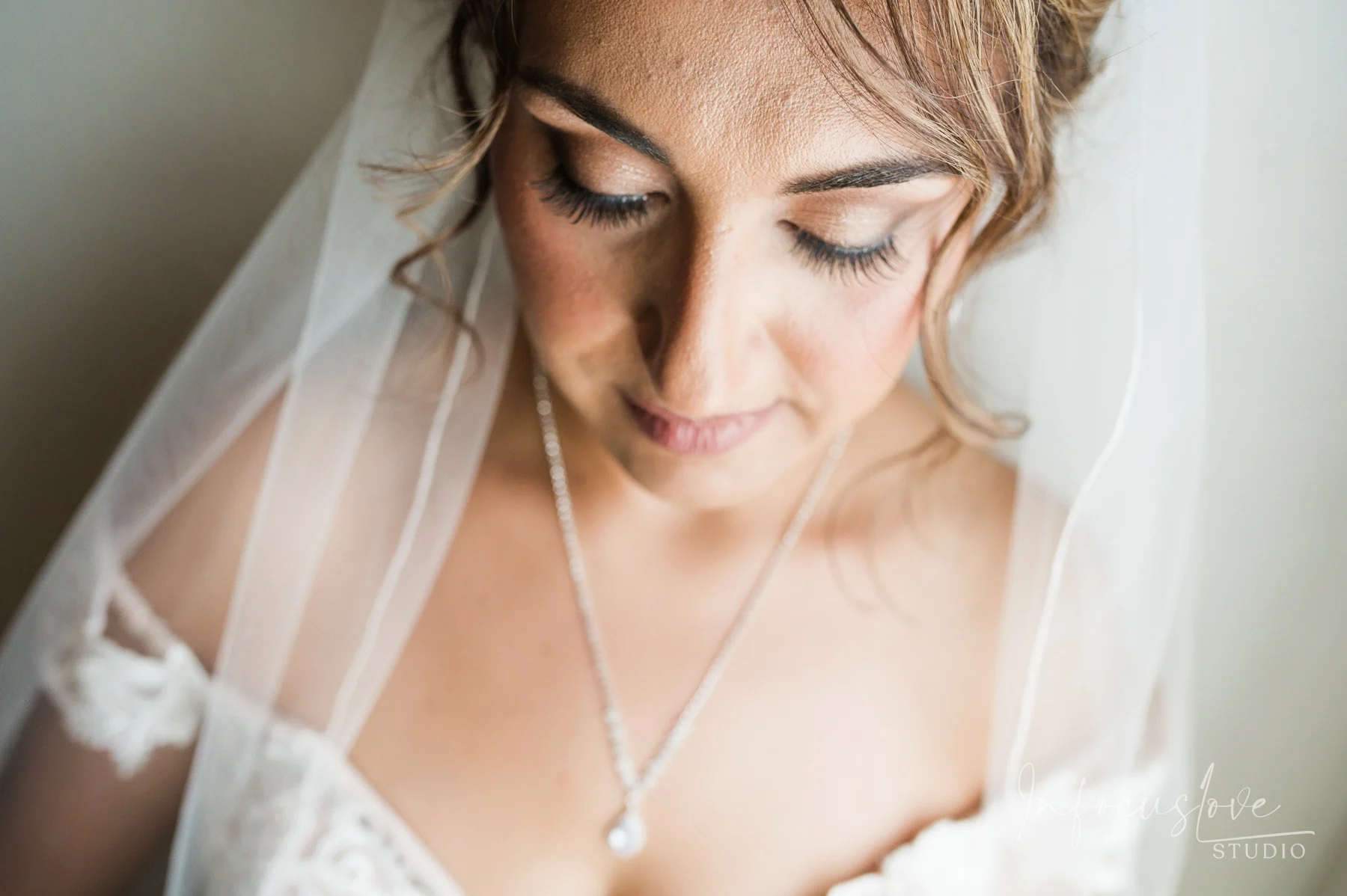 A bride looking down at her bouquet
