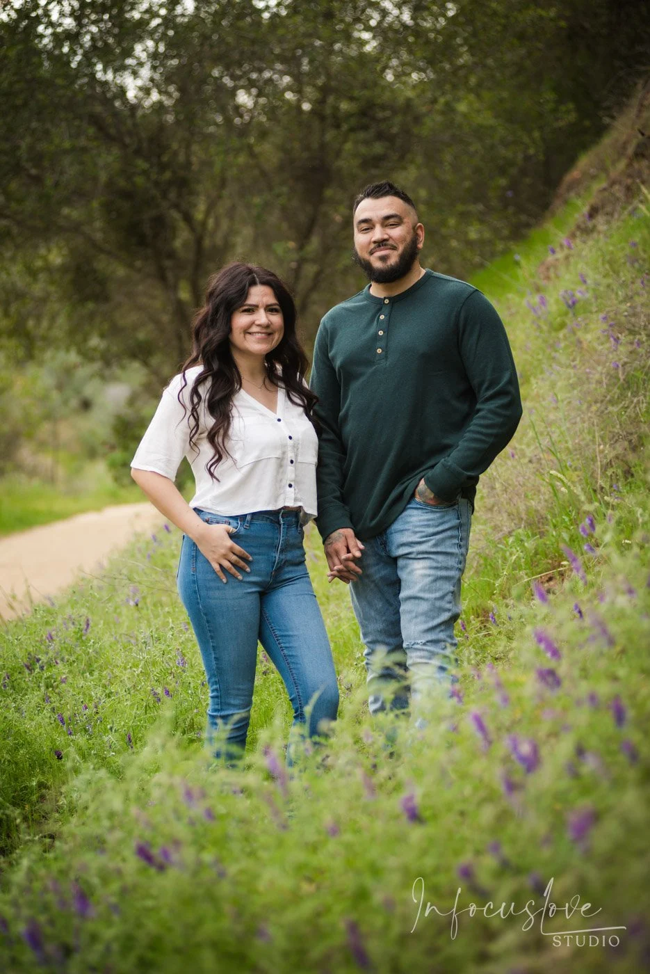 An engaged couple enjoying a green meadow