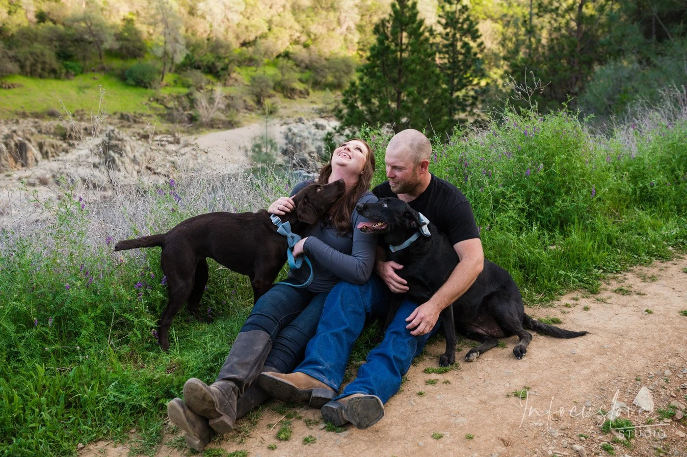 An engaged couple relaxing on a hillside