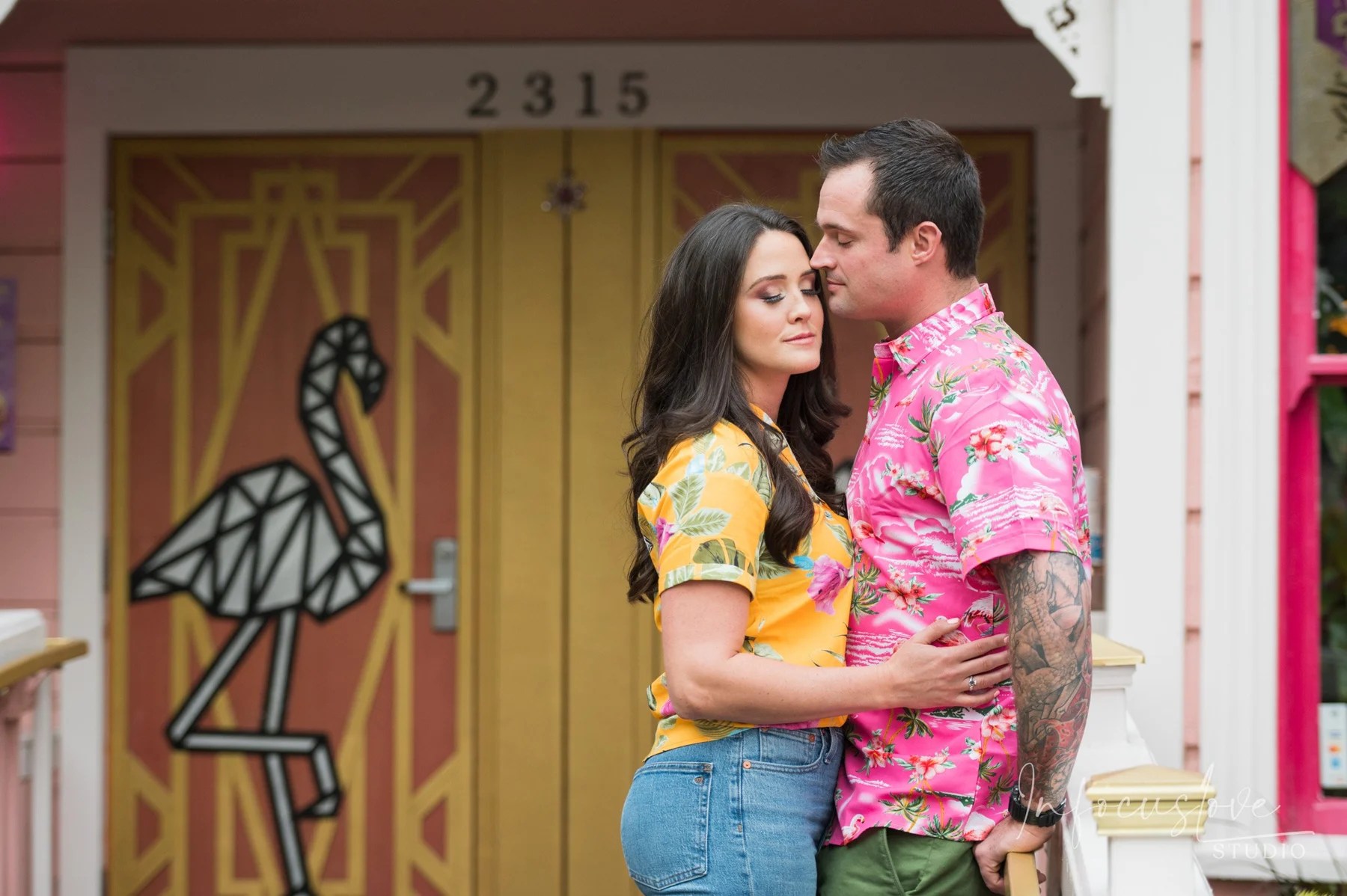 A colorful engagement portrait outside a doorway