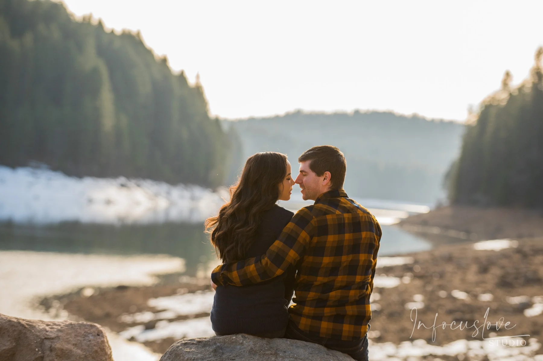 A couple embracing beside the water